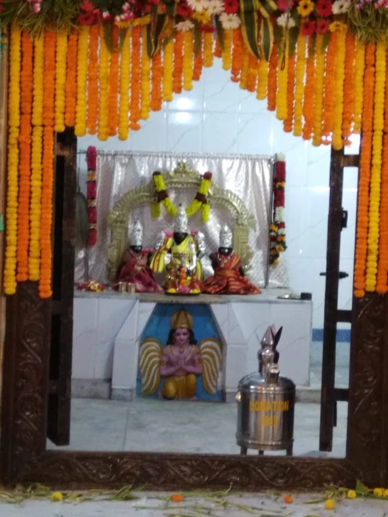 Present-day view into the sanctum of Sri Venkateswara Swamy Temple at Rail Bazaar, Alipurduar Junction, seen through the carved doorway.