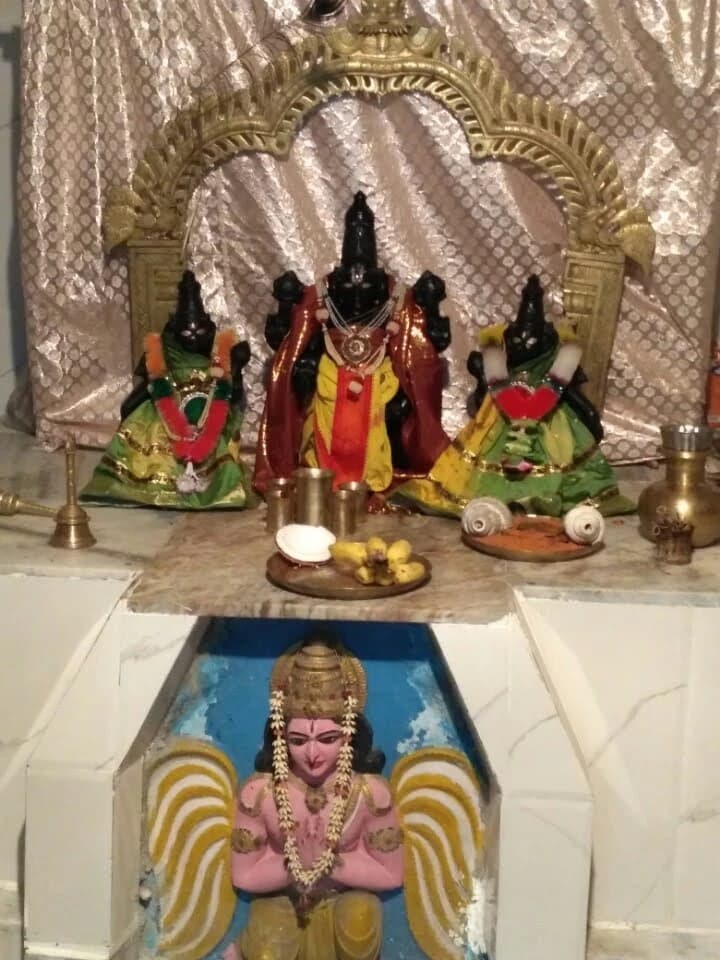 Earlier photograph of the inner shrine at Sri Venkateswara Swamy Temple, with the principal deities and offerings.