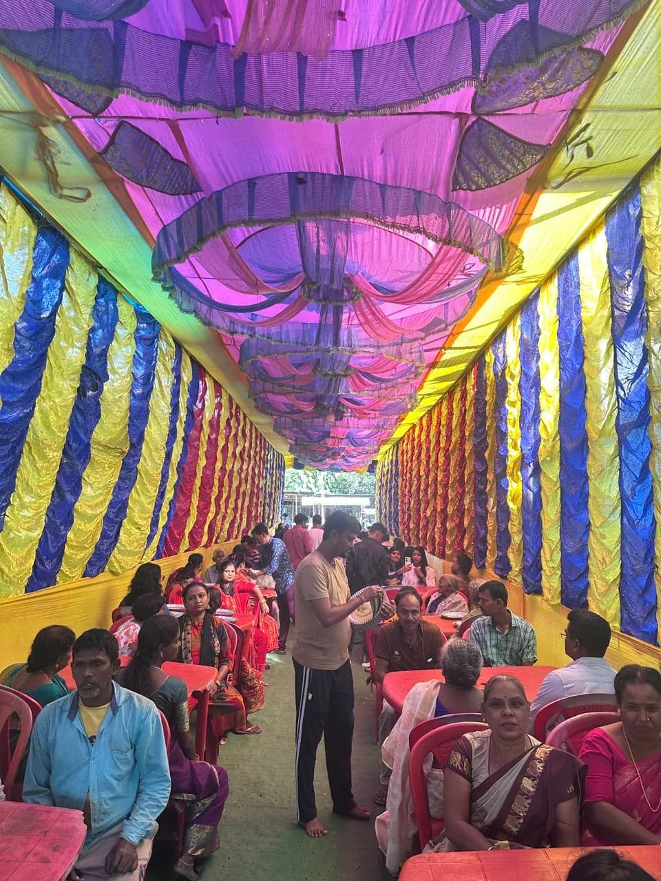 Community meal in a decorated pavilion associated with Sri Venkateswara Swamy Temple, Alipurduar