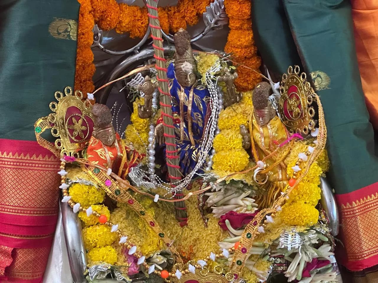 Processional deities of Sri Venkateswara Swamy Temple, dressed in silk and surrounded by flowers